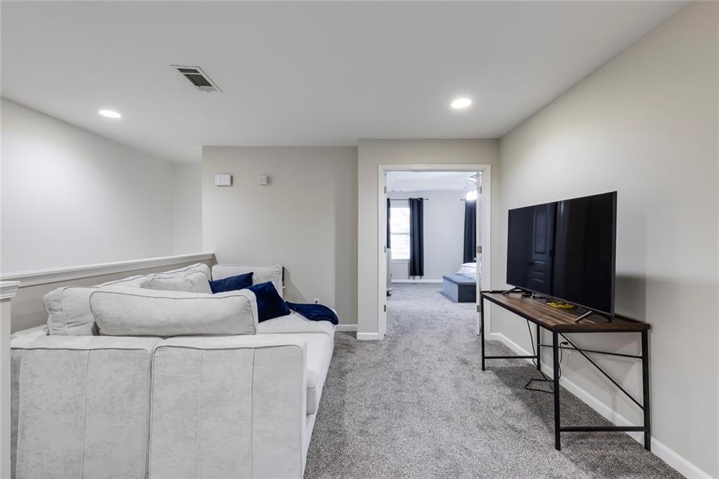1561 Trailview Way Northeast Atlanta, GA 30329 - Photo 25 of 38 a living room with furniture and a flat screen tv