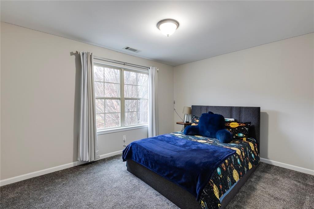 1561 Trailview Way Northeast Atlanta, GA 30329 - Photo 29 of 38 a bed sitting in a room next to a window