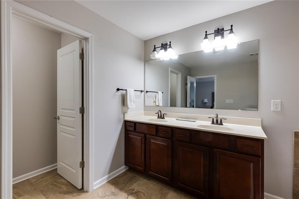 1561 Trailview Way Northeast Atlanta, GA 30329 - Photo 31 of 38 a bathroom with double vanity and a mirror