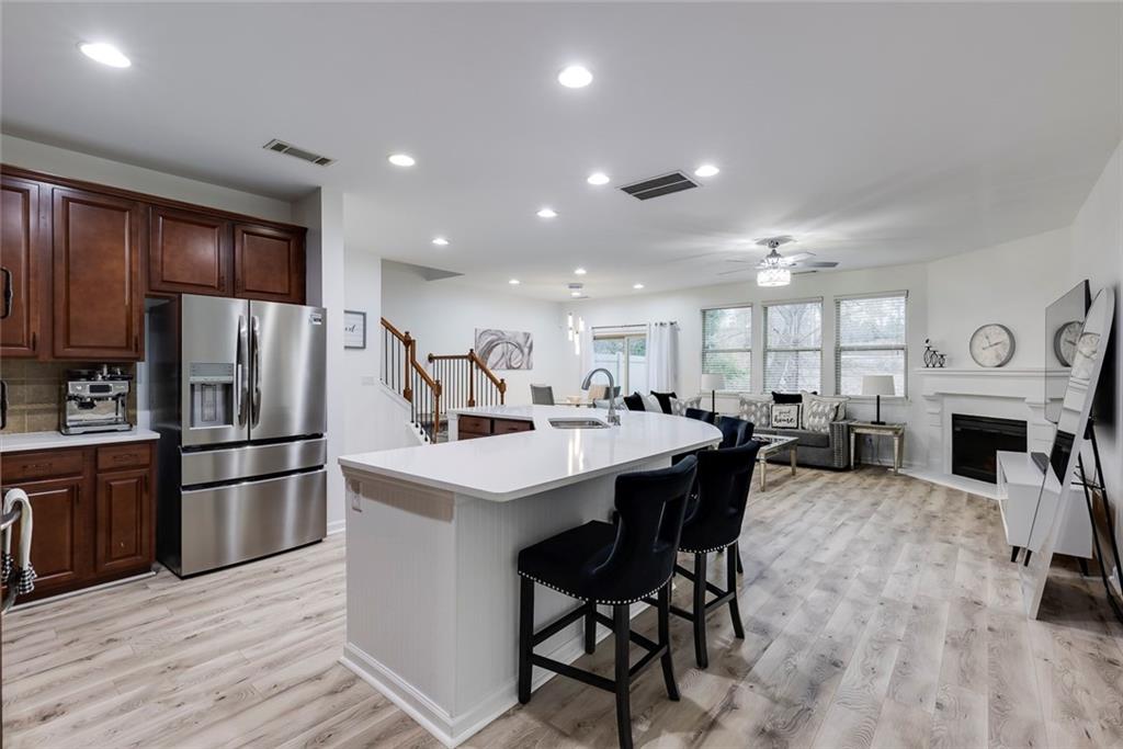 1561 Trailview Way Northeast Atlanta, GA 30329 - Photo 5 of 38 a kitchen with stainless steel appliances a dining table chairs stove refrigerator and fireplace