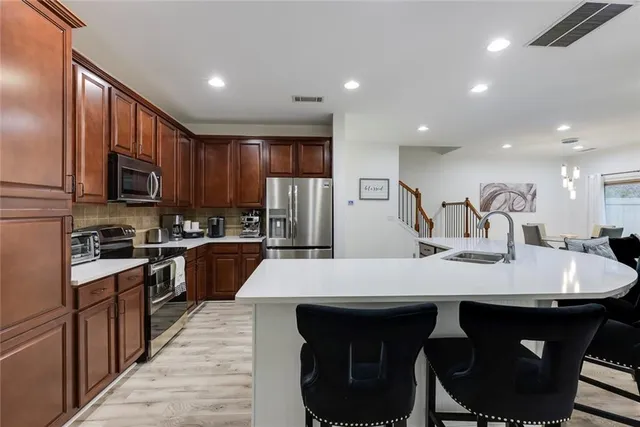 a large kitchen with kitchen island a sink counter space and stainless steel appliances