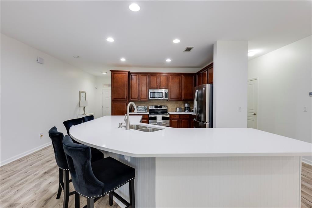 1561 Trailview Way Northeast Atlanta, GA 30329 - Photo 8 of 38 a kitchen with kitchen island a dining table and chairs