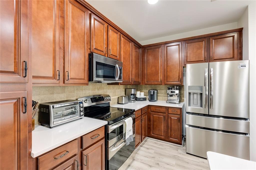 1561 Trailview Way Northeast Atlanta, GA 30329 - Photo 10 of 38 a kitchen with stainless steel appliances granite countertop a refrigerator stove microwave and sink