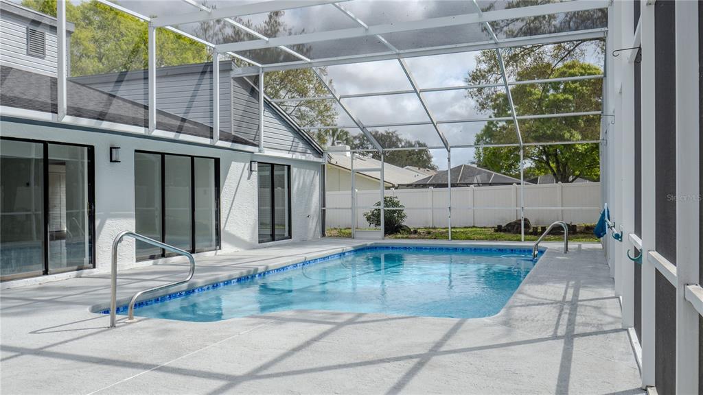 7984 Floral Drive Weeki Wachee, FL 34607 - Photo 30 of 31 a view of a backyard with a swimming pool
