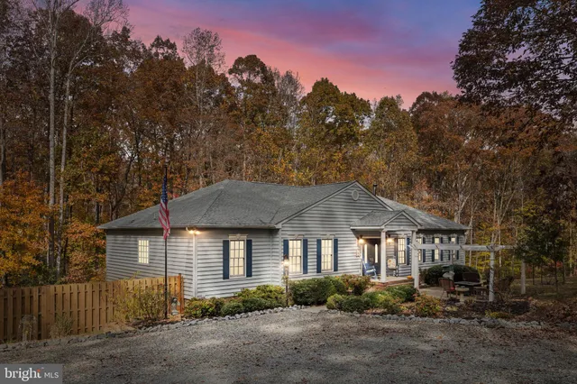 a view of a house with a porch and furniture