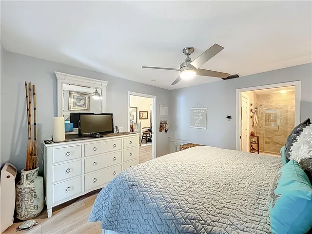 a en suite bathroom with a granite countertop sink and a large mirror