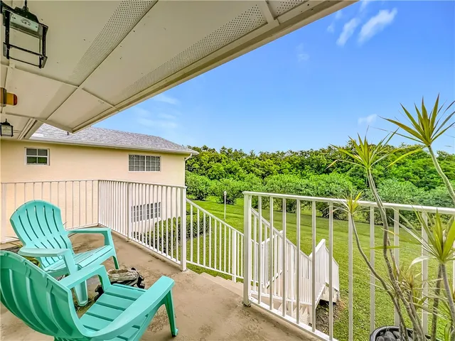 a view of a deck with a big yard