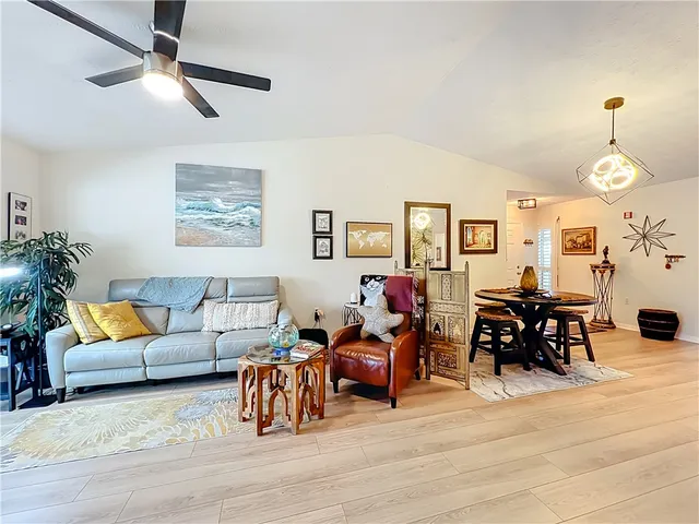 a living room with furniture wooden floor and a chandelier