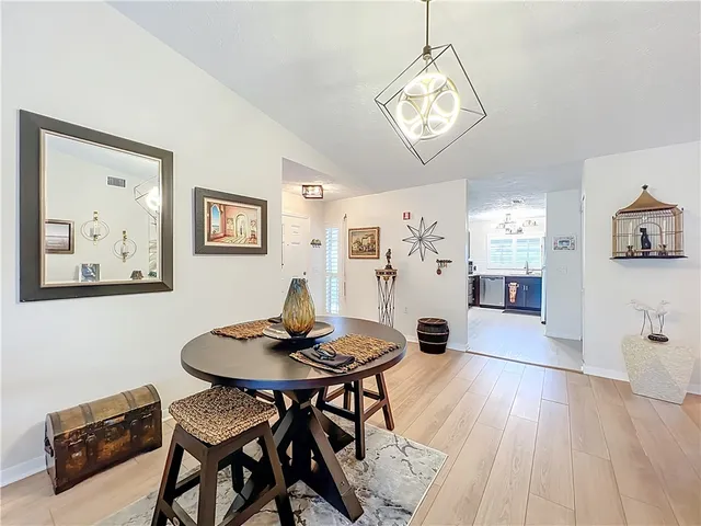 a view of a dining room with furniture and a chandelier