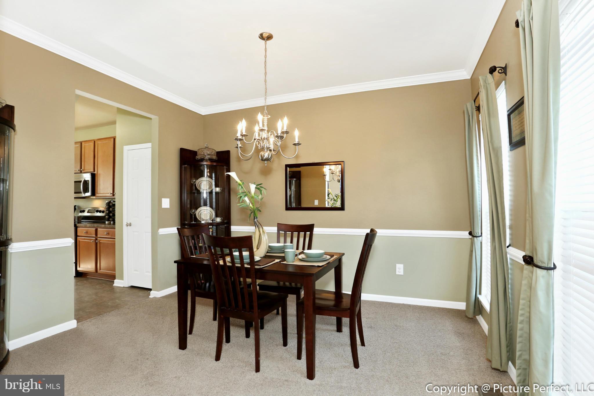 2120 Caisson Road Frederick, MD 21702 - Photo 3 of 30 Dining Room with Chair and Crown Molding
