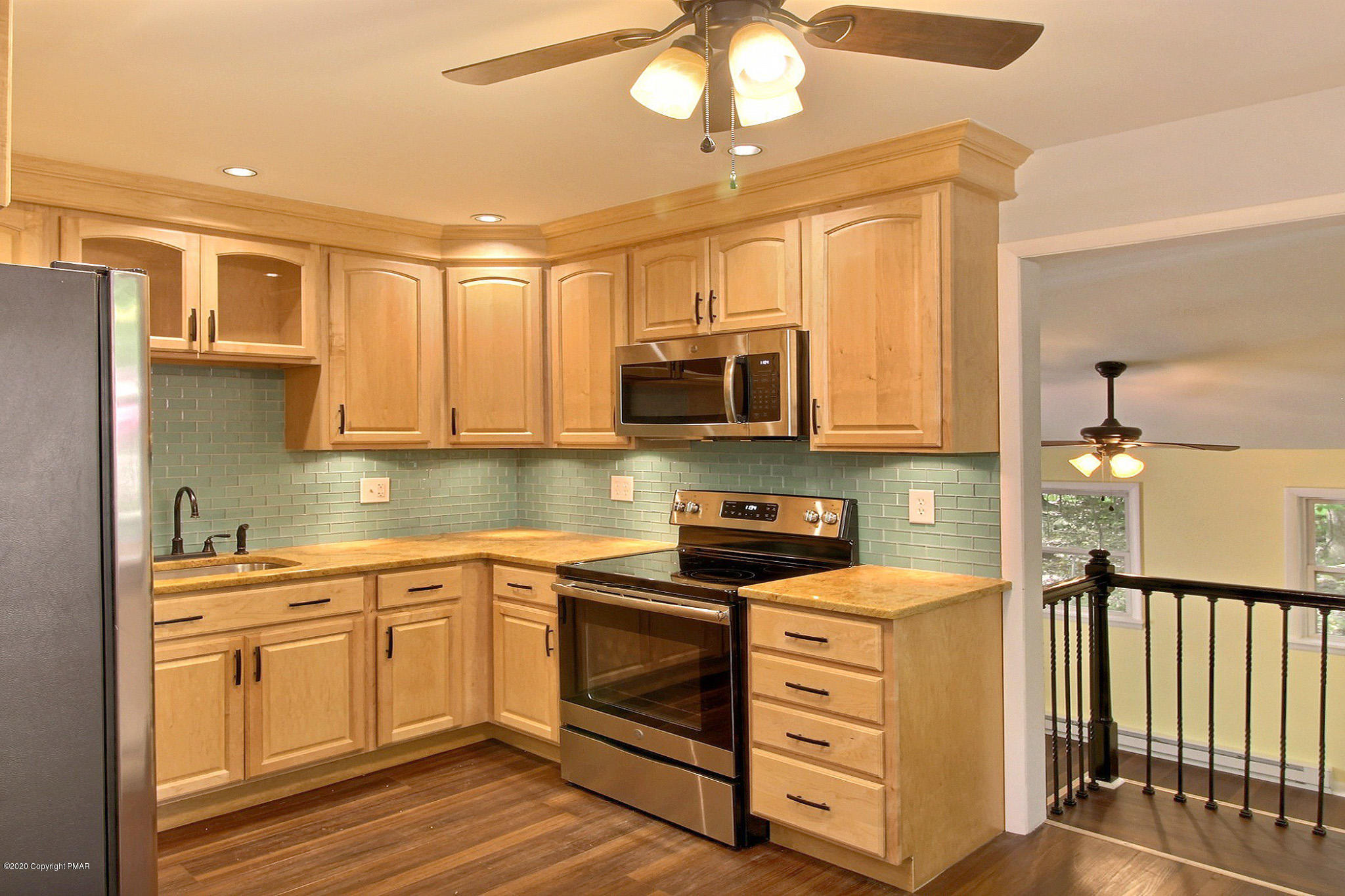 1191 Mattioli Road Bartonsville, PA 18321 - Photo 2 of 17 a kitchen with stainless steel appliances granite countertop a sink a stove cabinets and wooden floor