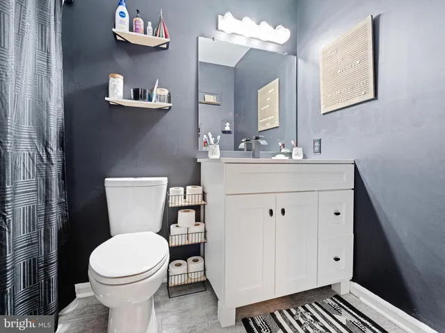 a white toilet sitting next to a bathroom sink