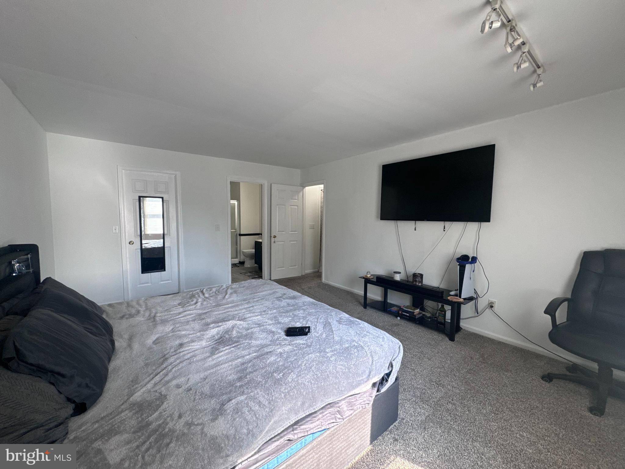 103 Osprey Court Camden Wyoming, DE 19934 - Photo 27 of 34 a bedroom with a bed and a flat screen tv