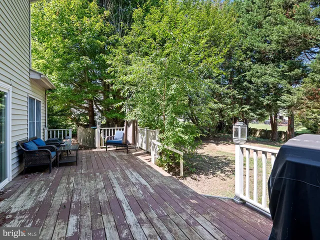 a view of a deck with furniture and garden
