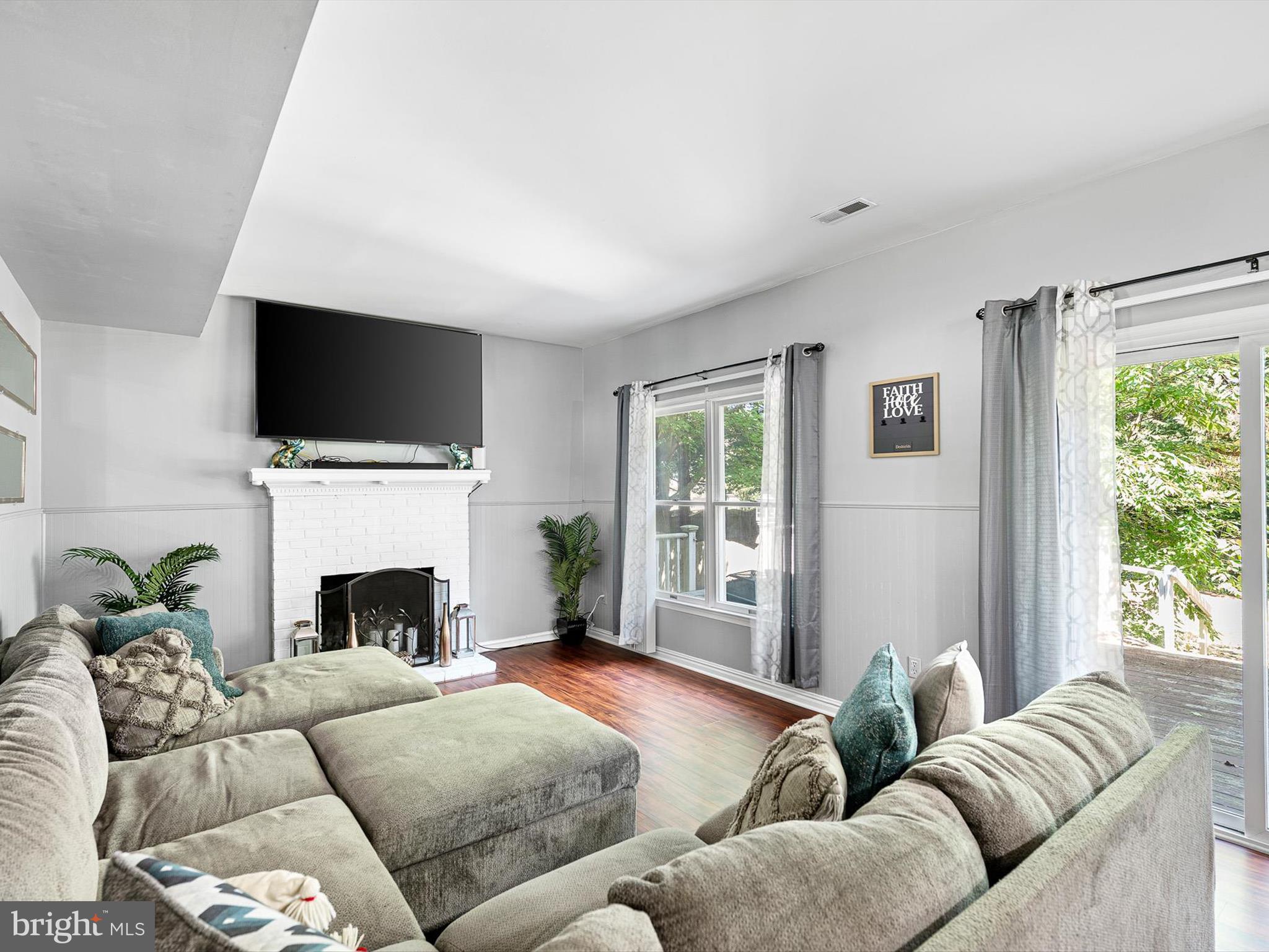 103 Osprey Court Camden Wyoming, DE 19934 - Photo 10 of 34 a living room with furniture a flat screen tv and a fireplace