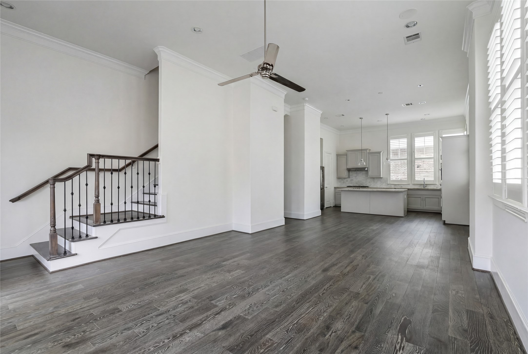 2613 Maxroy Street Houston, TX 77007 - Photo 17 of 43 Crown molding and trim details provide a finished, high-end look throughout. A striking stairwell design with classic iron detailing creates a refined transition between levels.
