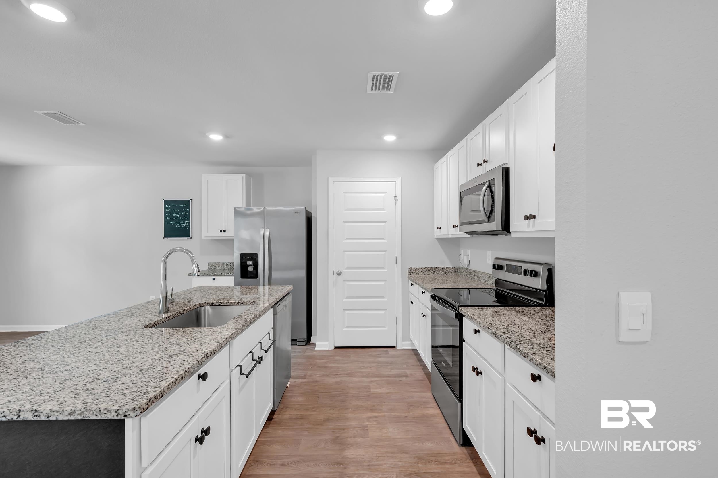 3070 Camino Real Loop Lillian, AL 36549 - Photo 14 of 46 Modern kitchen featuring an expansive center island with an undermount sink and a gooseneck faucet