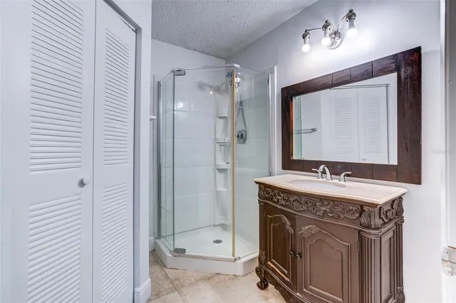 a spacious bathroom with a sink a mirror and a shower
