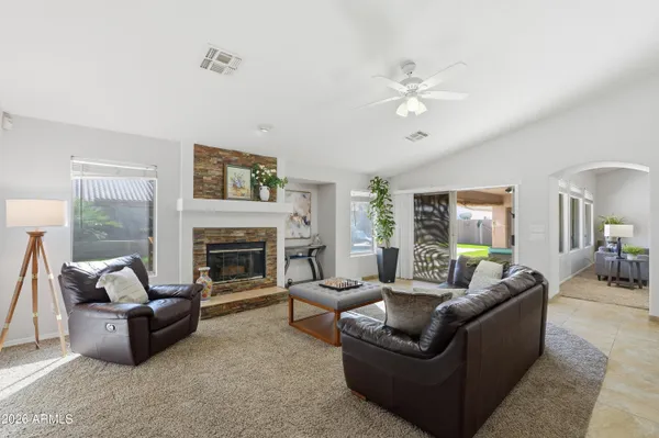 a living room with furniture and a fireplace