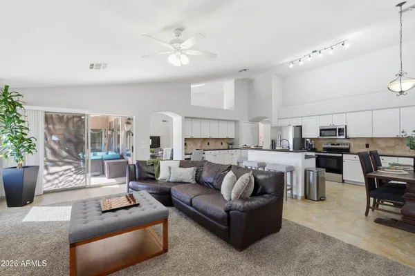 a living room with furniture and a view of kitchen