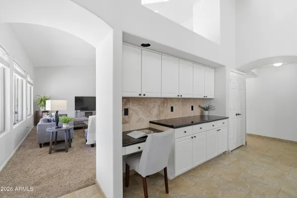 a kitchen with granite countertop a sink appliances cabinets and furniture