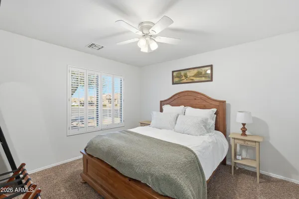 a bedroom with a large bed and a window