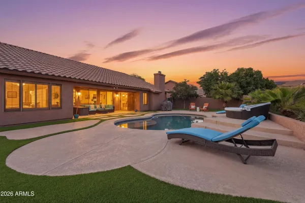 a swimming pool with outdoor seating and yard