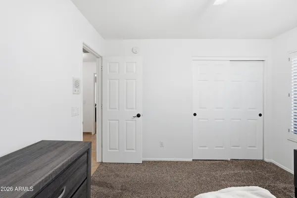 a room with a bed and a cabinet