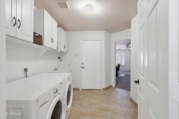 a view of storage and utility room with washer and dryer