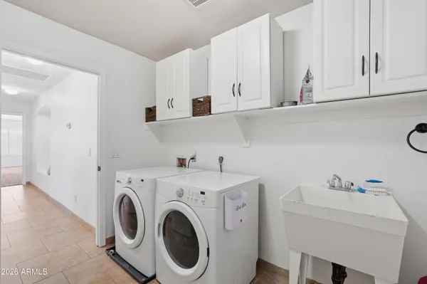 a view of kitchen with sink washer and dryer