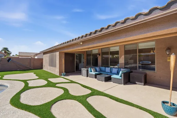 a swimming pool with outdoor seating and yard