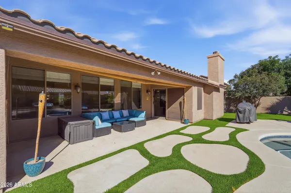 a view of an house with backyard furniture and porch