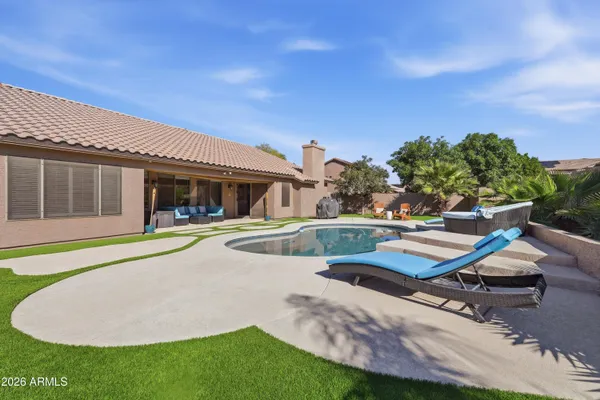 a view of house with swimming pool outdoor seating