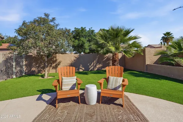 a view of a table and chairs in the garden