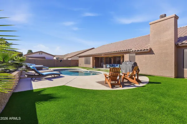a view of a house with backyard porch and sitting area
