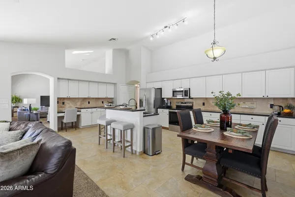 a view of kitchen with cabinets table and chairs