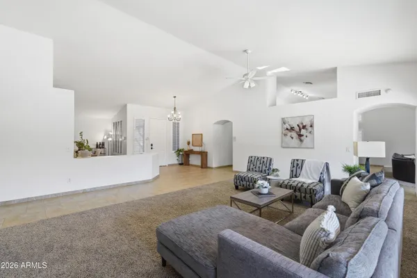 a living room with furniture and kitchen view