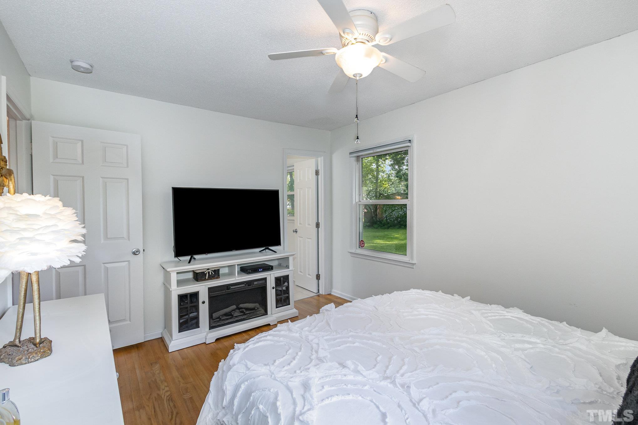 1712 Riverview Road Raleigh, NC 27610 - Photo 15 of 27 a bedroom with a bed and a flat screen tv
