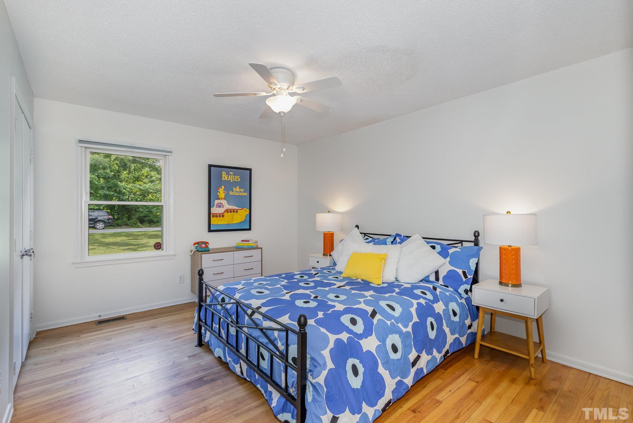 1712 Riverview Road Raleigh, NC 27610 - Photo 17 of 27 a bedroom with a bed and wooden floor