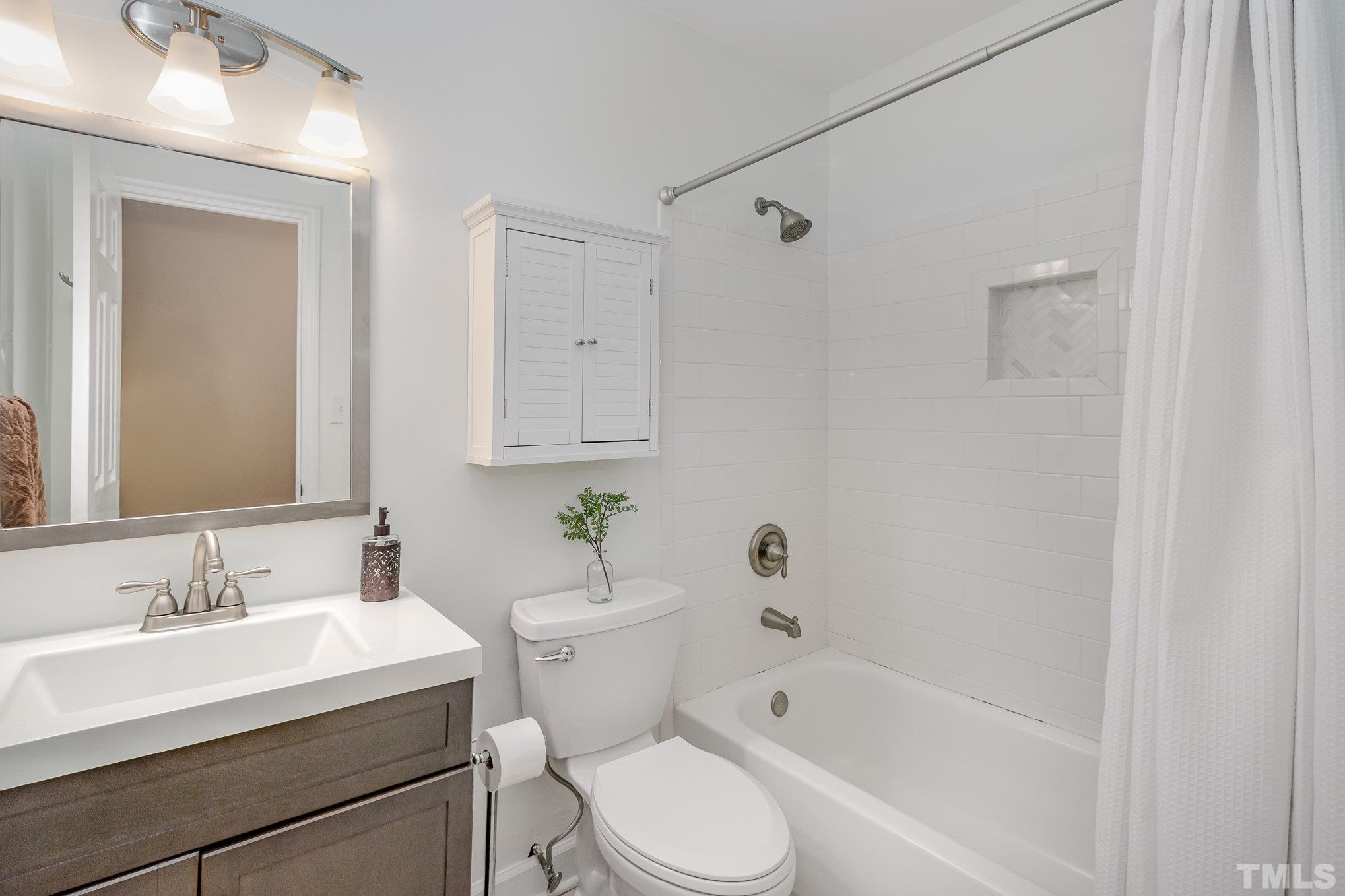 1712 Riverview Road Raleigh, NC 27610 - Photo 19 of 27 a bathroom with a sink toilet and shower