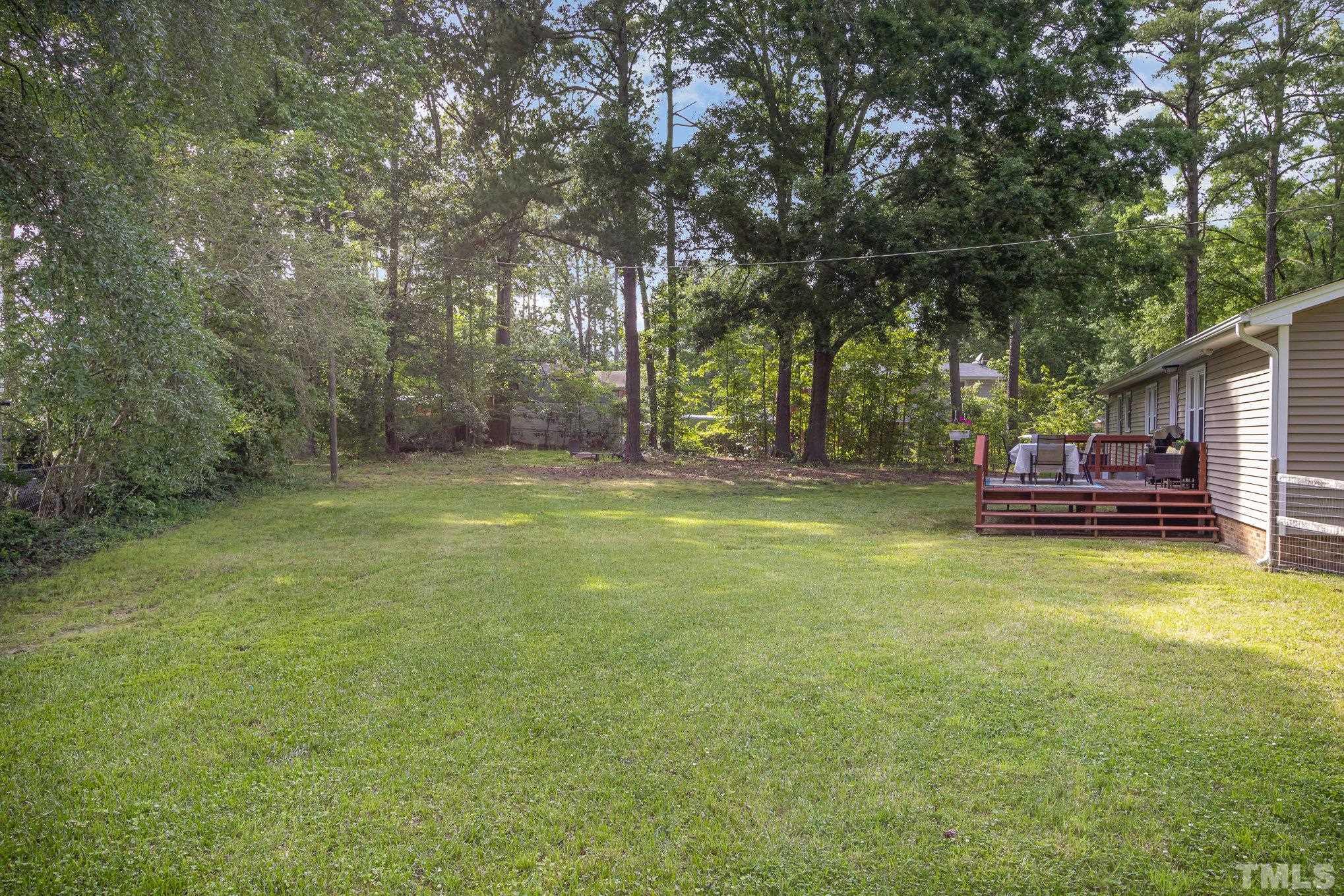 1712 Riverview Road Raleigh, NC 27610 - Photo 21 of 27 a view of a swimming pool with trees in the background