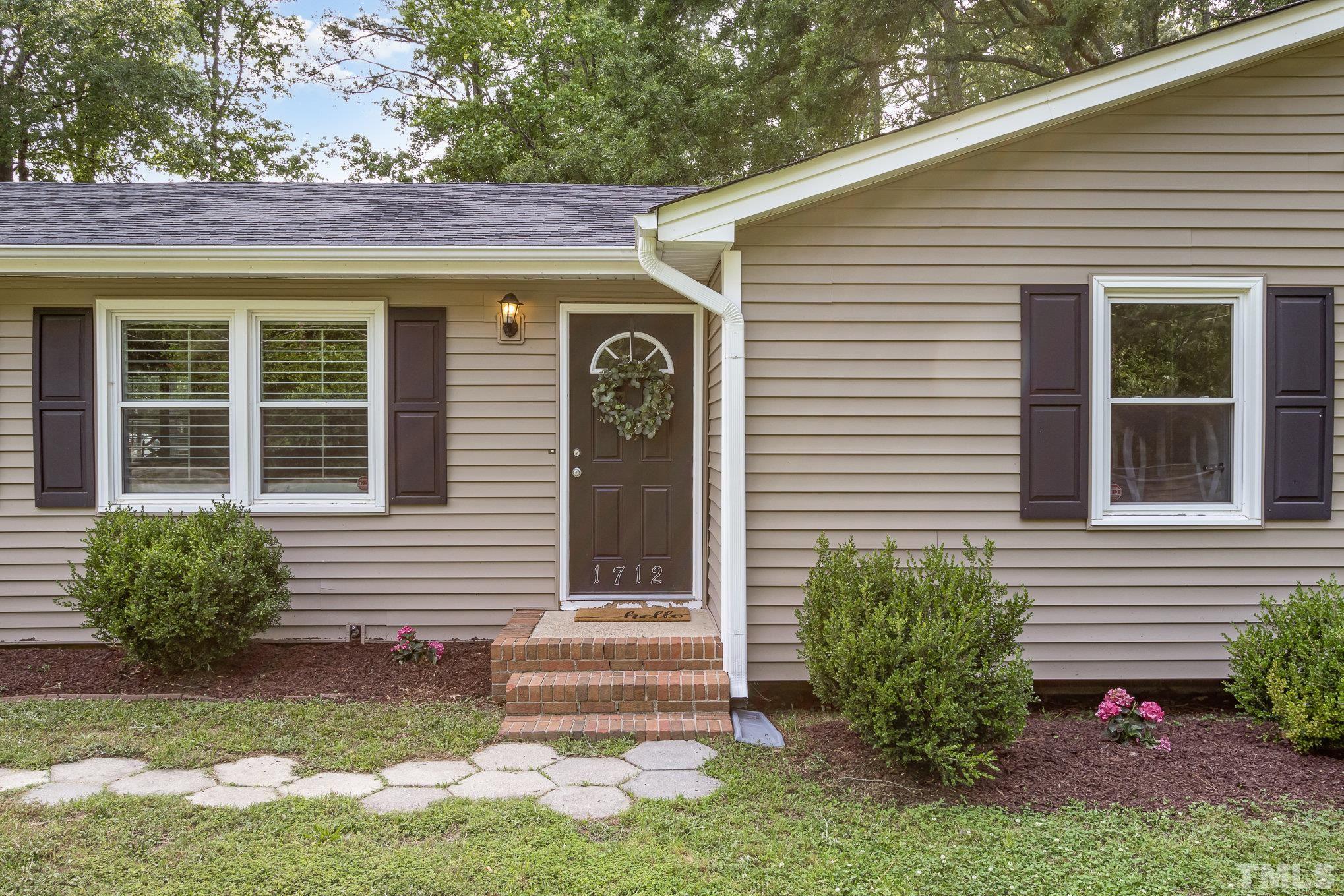 1712 Riverview Road Raleigh, NC 27610 - Photo 3 of 27 a front view of a house with a yard