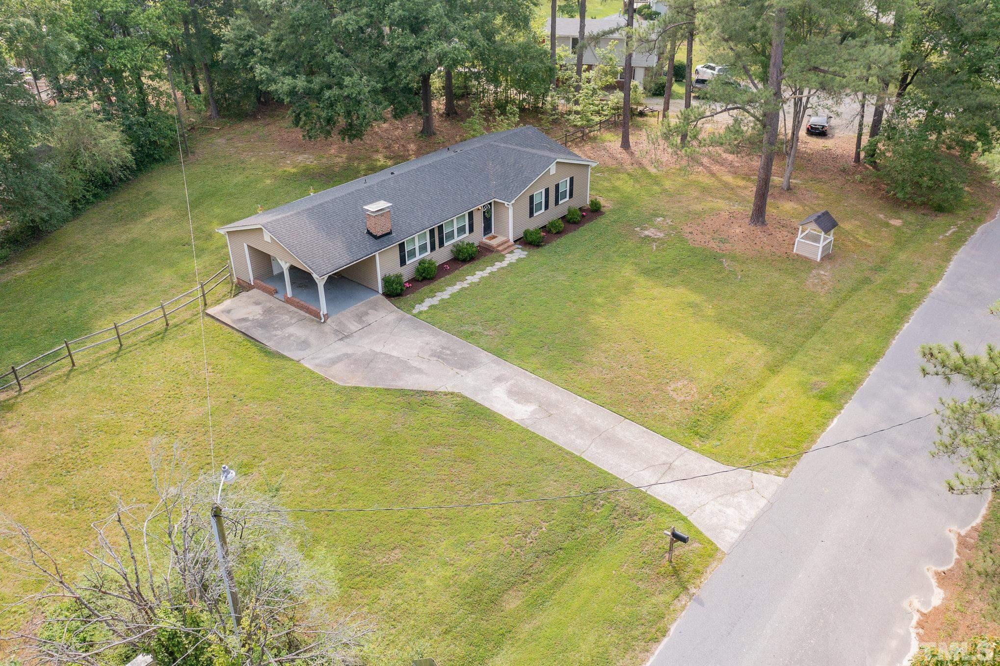 1712 Riverview Road Raleigh, NC 27610 - Photo 5 of 27 a view of a big yard with an outdoor space