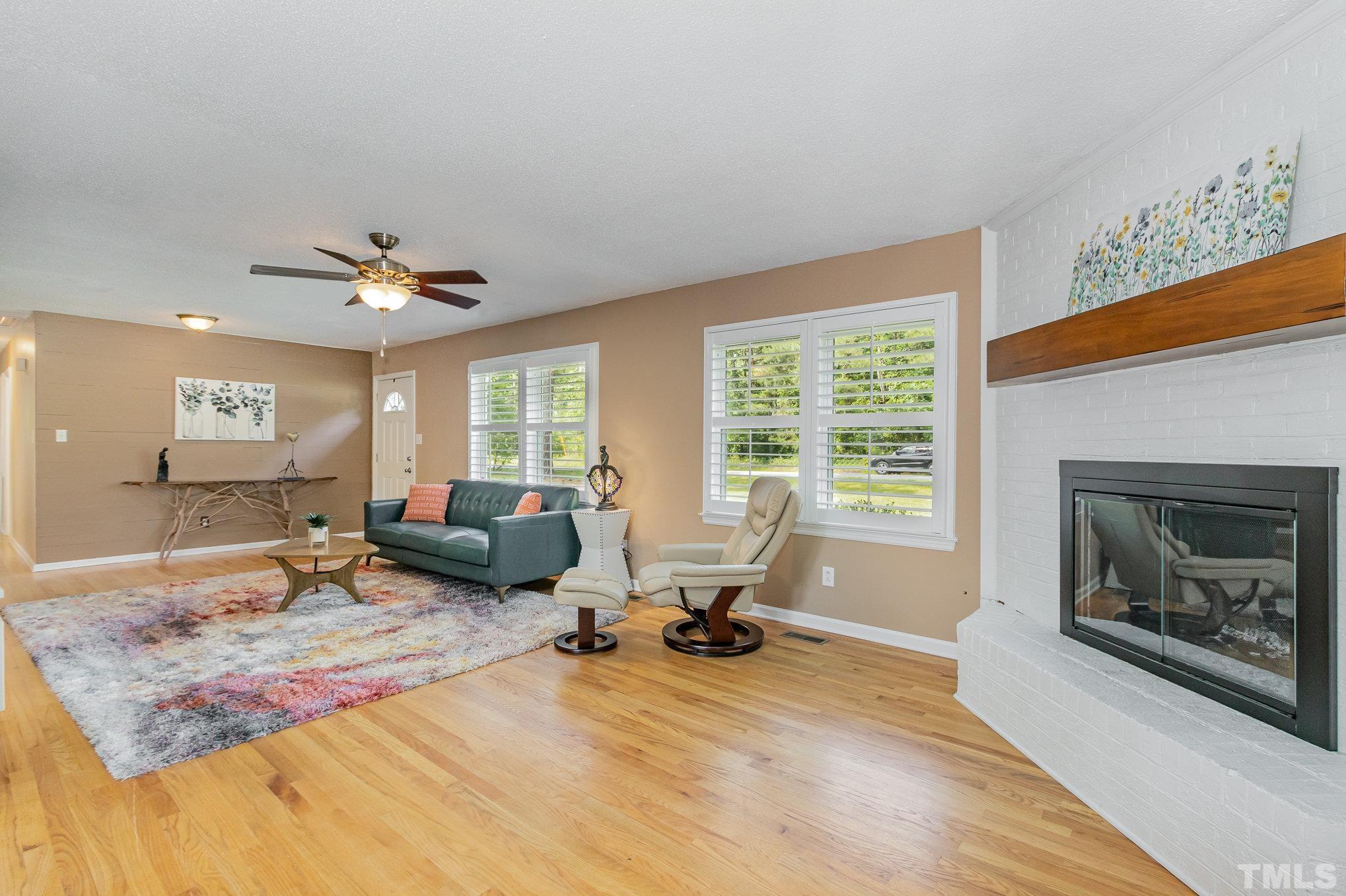 1712 Riverview Road Raleigh, NC 27610 - Photo 8 of 27 a living room with furniture and a fireplace