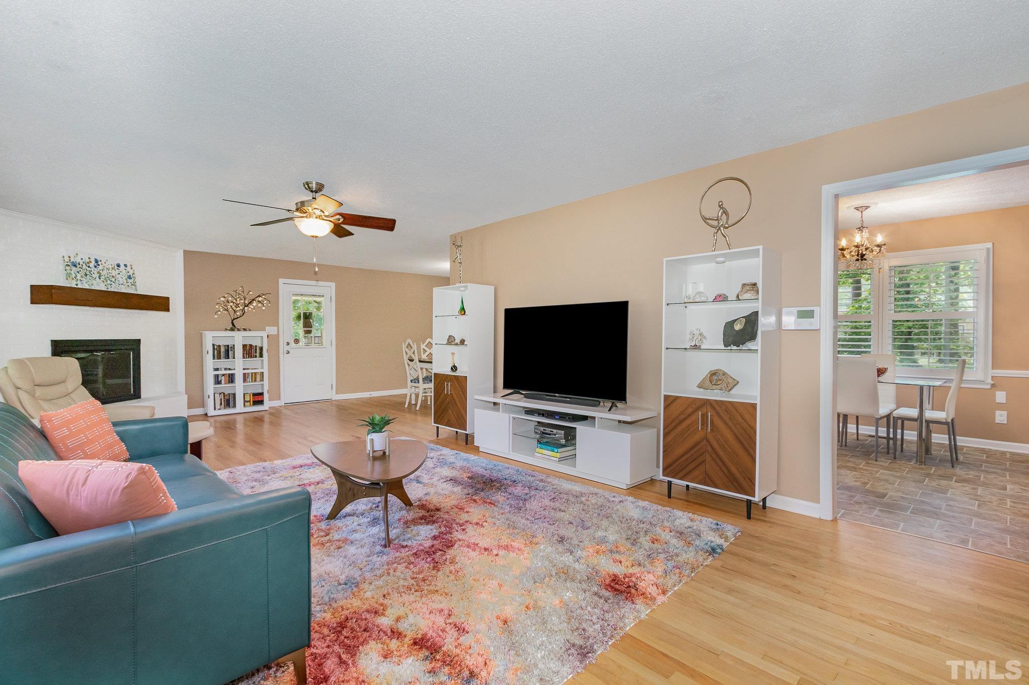 1712 Riverview Road Raleigh, NC 27610 - Photo 9 of 27 a living room with furniture and a flat screen tv