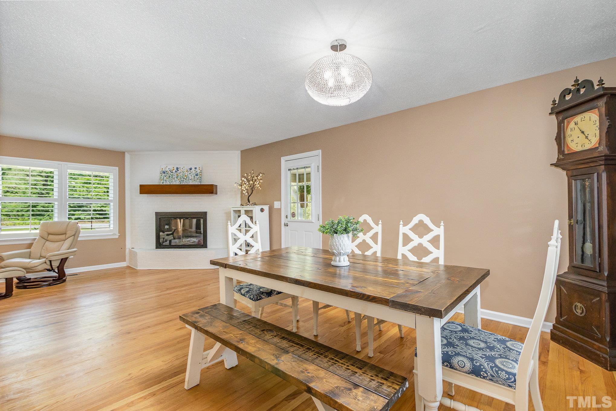 1712 Riverview Road Raleigh, NC 27610 - Photo 10 of 27 a living room with furniture a fireplace and a table