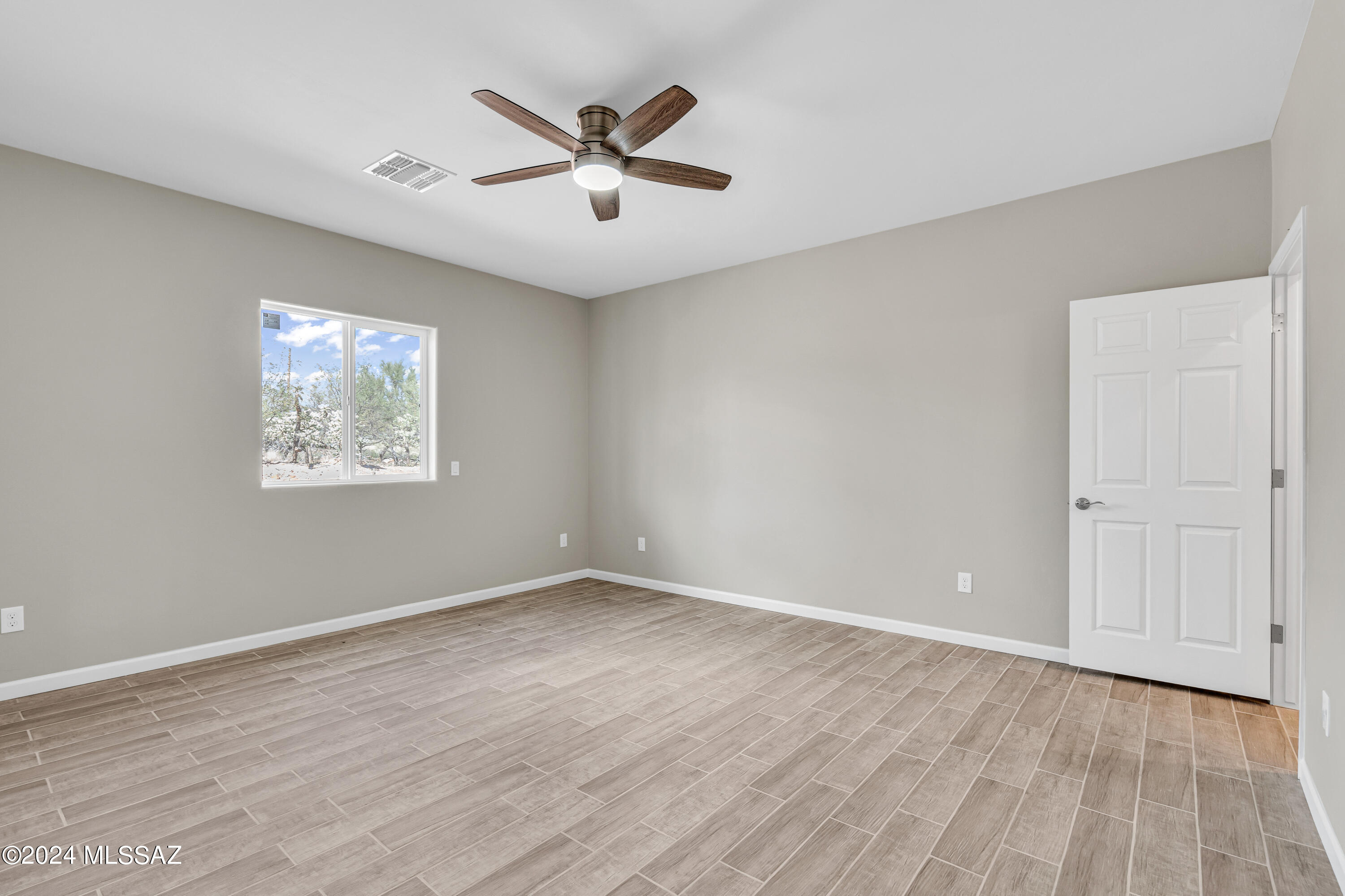 103 Headge Court Rio Rico, AZ 85648 - Photo 18 of 35 an empty room with wooden floor and windows