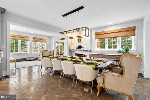 a kitchen with stainless steel appliances granite countertop a sink a stove and a wooden cabinets with large window