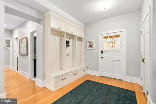 a bedroom with two beds and a dresser next to a window
