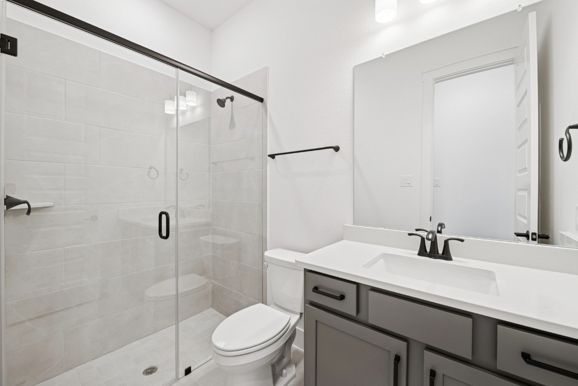 8731 Mancos Valley Porter, TX 77365 - Photo 18 of 46 a bathroom with a sink a toilet and shower